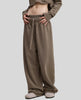 Front angled view of a model wearing the Heritage Washed Pants in Coffee