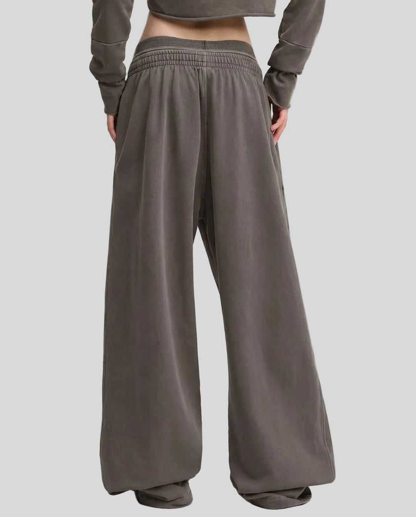 Back view of a model wearing the Heritage Washed Pants in Dark Gray