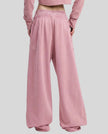 Back view of a model wearing the Heritage Washed Pants in Rose Pink