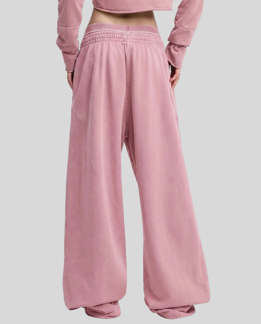 Back view of a model wearing the Heritage Washed Pants in Rose Pink