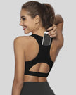 Back-cutout sports bra with integrated phone pocket shown in black