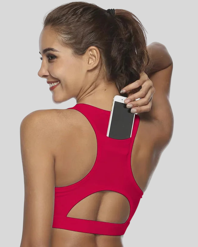 Back-cutout sports bra with integrated phone pocket shown in deep red