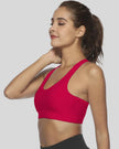 Sports bra with sculpted scoop neckline shown from left side angle in deep red