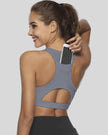 Back-cutout sports bra with integrated phone pocket shown in gray