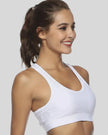 Supportive scoop-neck sports bra shown from right front angle in white