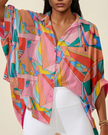 Closeup of multicolor retro-inspired print and button-front detail on oversized shirt