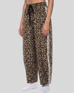 Lower body front angle view of woman wearing Leopard Accent Barrel Pants in Leopard Coffee