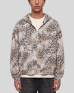 Upper body front view of man wearing Leopard Vintage Accent Hoodie zipped closed in Leopard Apricot
