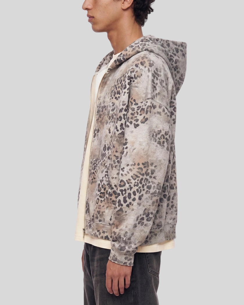 Upper body side view of man wearing oversized Leopard Vintage Accent Hoodie in Leopard Apricot