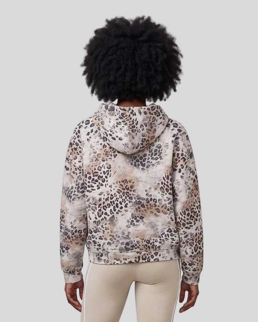 Upper body back view of woman wearing Leopard Vintage Accent Hoodie with oversized hood in Leopard Apricot