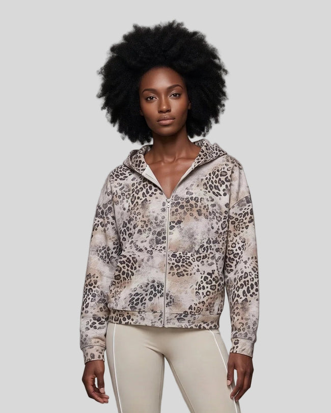Upper body front view of woman wearing Leopard Vintage Accent Hoodie zipped closed in Leopard Apricot
