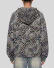 A woman shown from the back wearing a leopard dark gray Athlesi Leopard Vintage Accent Hoodie with light-wash blue jeans against a plain white background