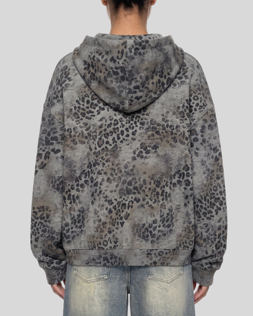 A woman shown from the back wearing a leopard dark gray Athlesi Leopard Vintage Accent Hoodie with light-wash blue jeans against a plain white background