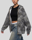Upper body side angle view of woman wearing oversized Leopard Vintage Accent Hoodie in Leopard Dark Gray