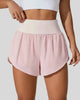 Front view of Athlesi LiftMove Pocket Active Shorts in blush pink with high-rise waistband and relaxed outer layer