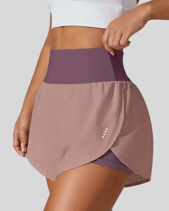 Front left angle of Athlesi LiftMove Pocket Active Shorts in dusty pink showing flowy silhouette