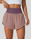 Front view of Athlesi LiftMove Pocket Active Shorts in dusty pink with high-rise waistband and relaxed outer layer