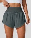 Front view of Athlesi LiftMove Pocket Active Shorts in gray with high-rise waistband and relaxed outer layer