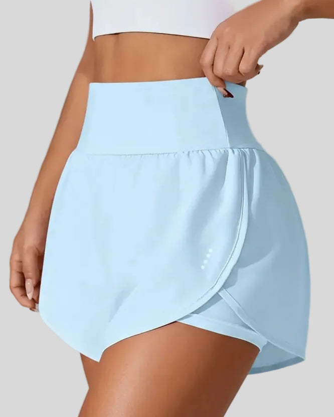 Front left angle of Athlesi LiftMove Pocket Active Shorts in light blue showing flowy silhouette