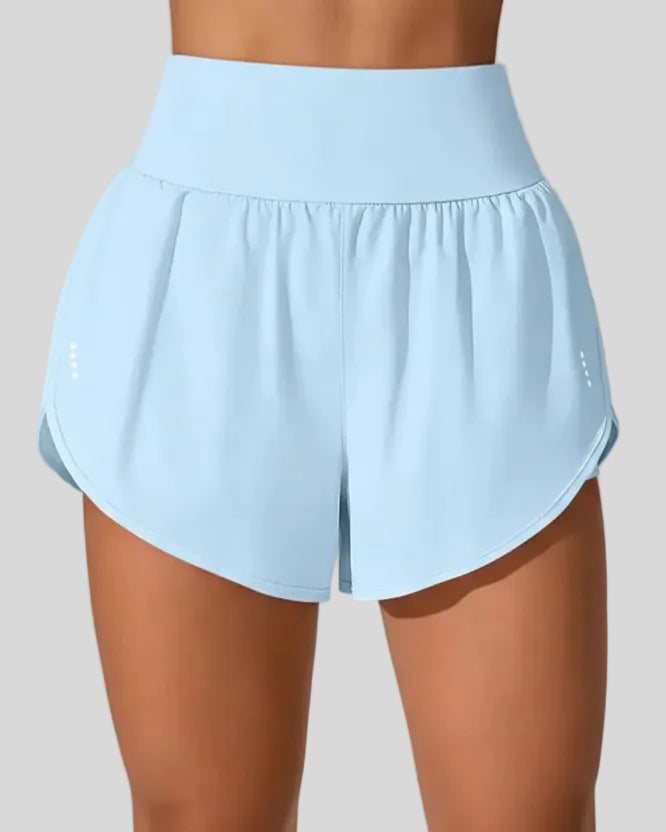 Front view of Athlesi LiftMove Pocket Active Shorts in light blue with high-rise waistband and relaxed outer layer