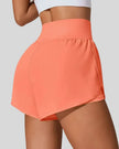 Back view of Athlesi LiftMove Pocket Active Shorts in orange showing smooth waistband and coverage