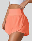 Front left angle of Athlesi LiftMove Pocket Active Shorts in orange showing flowy silhouette