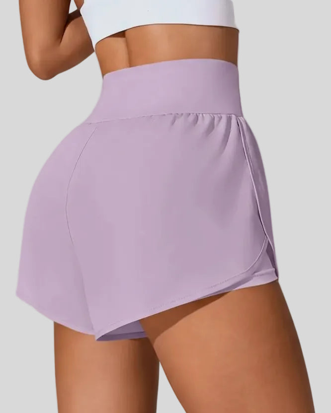 Back view of Athlesi LiftMove Pocket Active Shorts in dusty pink showing smooth waistband and coverage