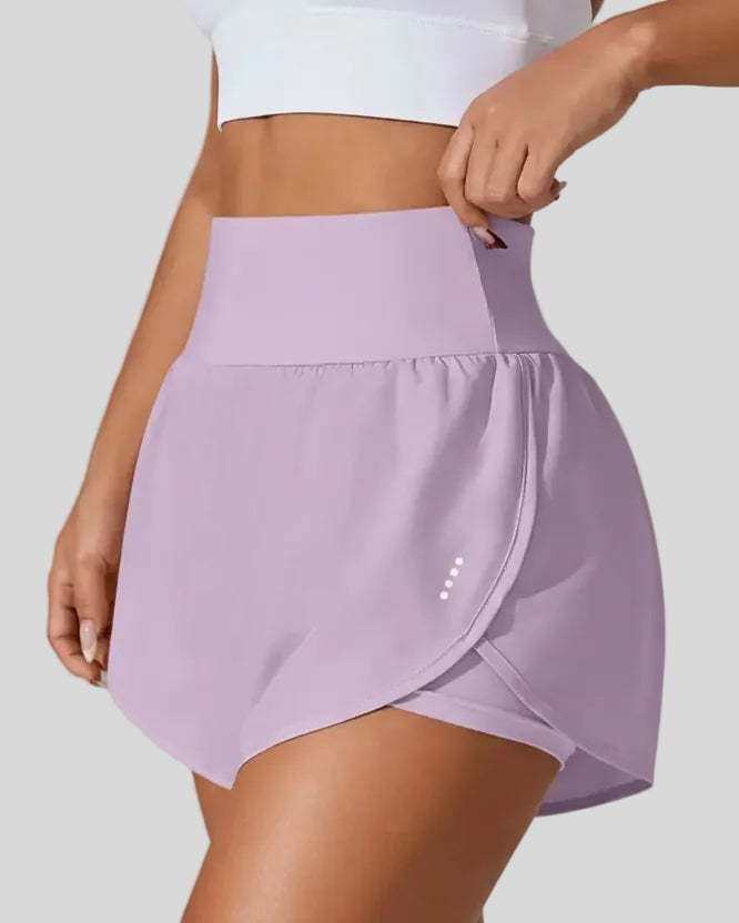 Front left angle of Athlesi LiftMove Pocket Active Shorts in pink purple showing flowy silhouette
