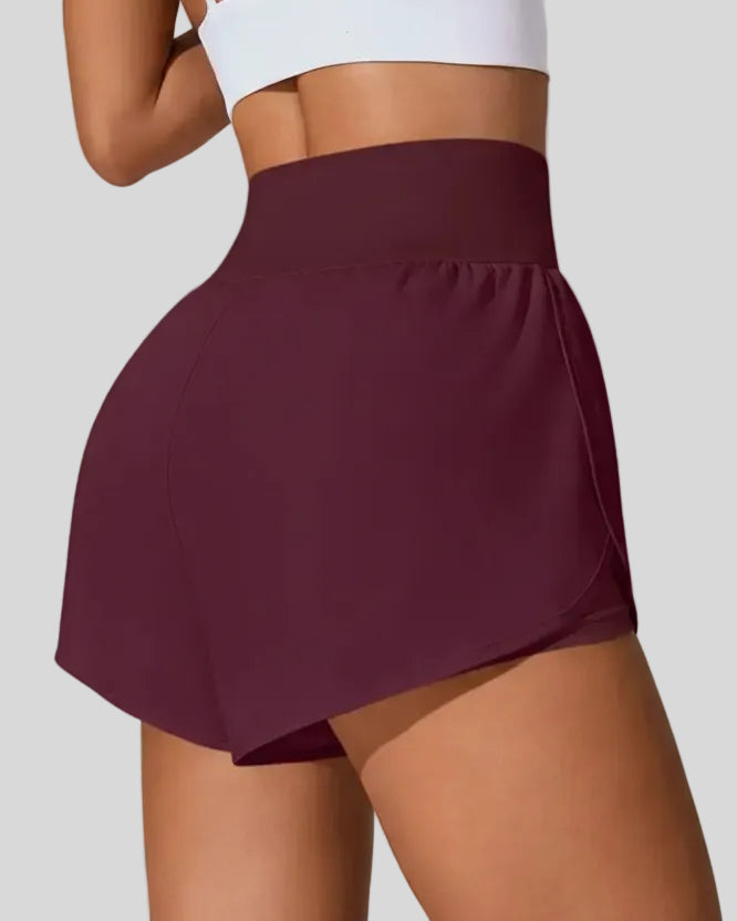 Back view of Athlesi LiftMove Pocket Active Shorts in plum purple showing smooth waistband and coverage