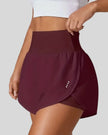 Front left angle of Athlesi LiftMove Pocket Active Shorts in plum purple showing flowy silhouette