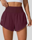 Front view of Athlesi LiftMove Pocket Active Shorts in plum purple with high-rise waistband and relaxed outer layer