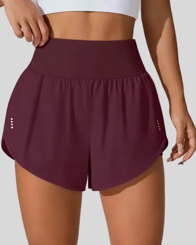 Front view of Athlesi LiftMove Pocket Active Shorts in plum purple with high-rise waistband and relaxed outer layer