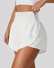 Front left angle of Athlesi LiftMove Pocket Active Shorts in white showing flowy silhouette