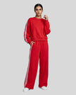 Front angle view of model wearing Athlesi LineFlow Crewneck Lounge Set in Deep Rose