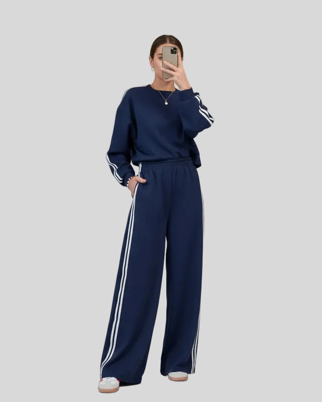 Navy two-piece lounge set with crewneck top and striped sweatpants, front full body view
