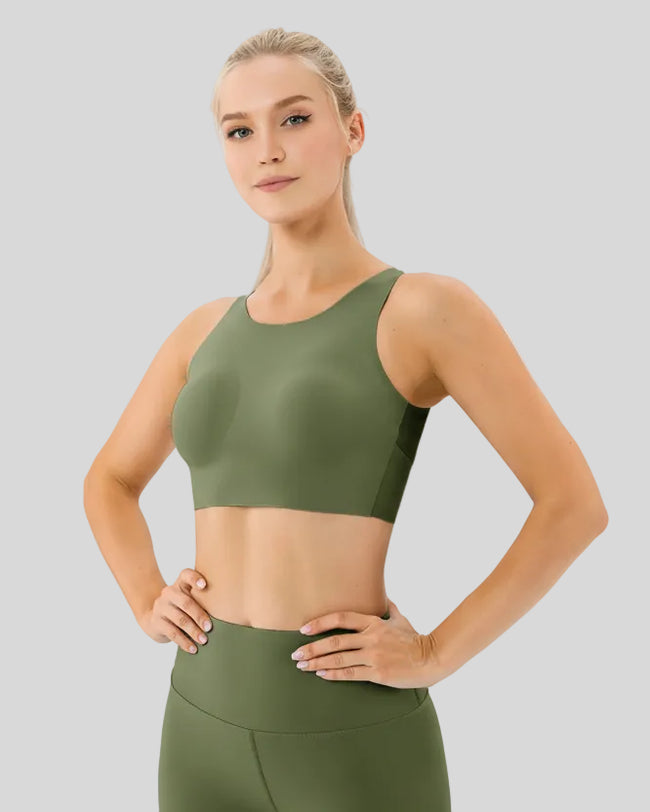 Front left angle of Athlesi LineForm Sports Bra in green highlighting wide supportive straps