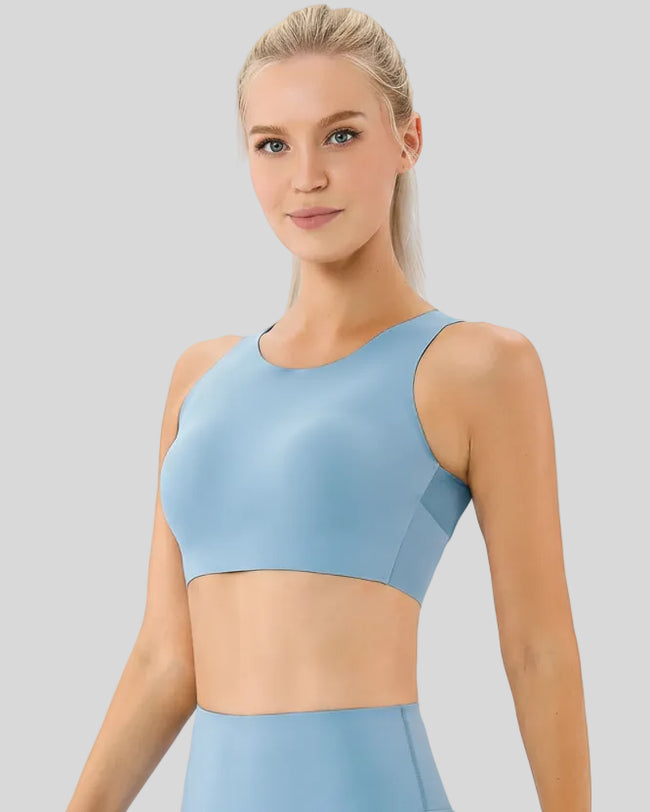 Close-up angled view of Athlesi LineForm Sports Bra in light blue showing smooth compression fabric