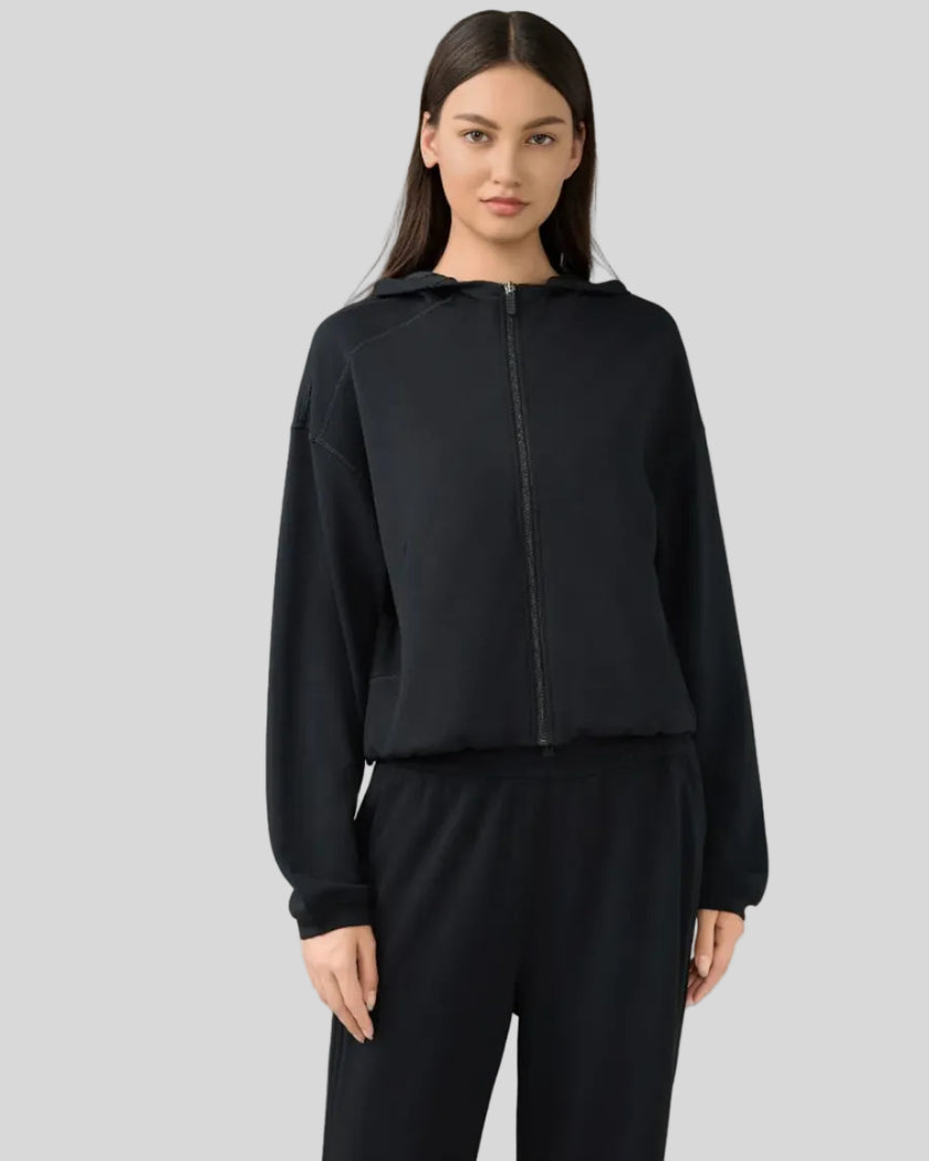 Angled front view showing dropped shoulders and clean zip-up design in Black