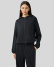 Black zip-up hoodie with relaxed fit and dropped shoulders, front view.
