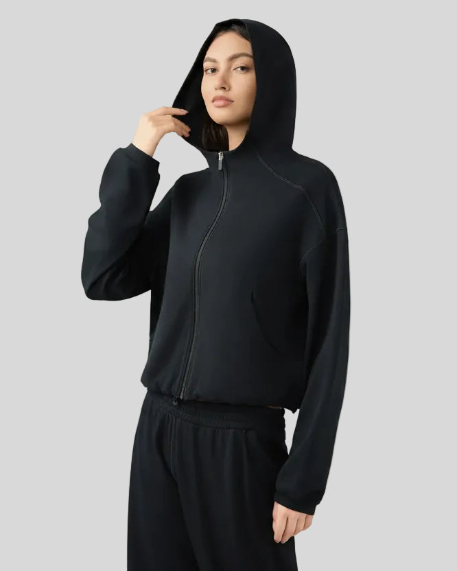 Side view highlighting relaxed silhouette and soft fabric drape in black