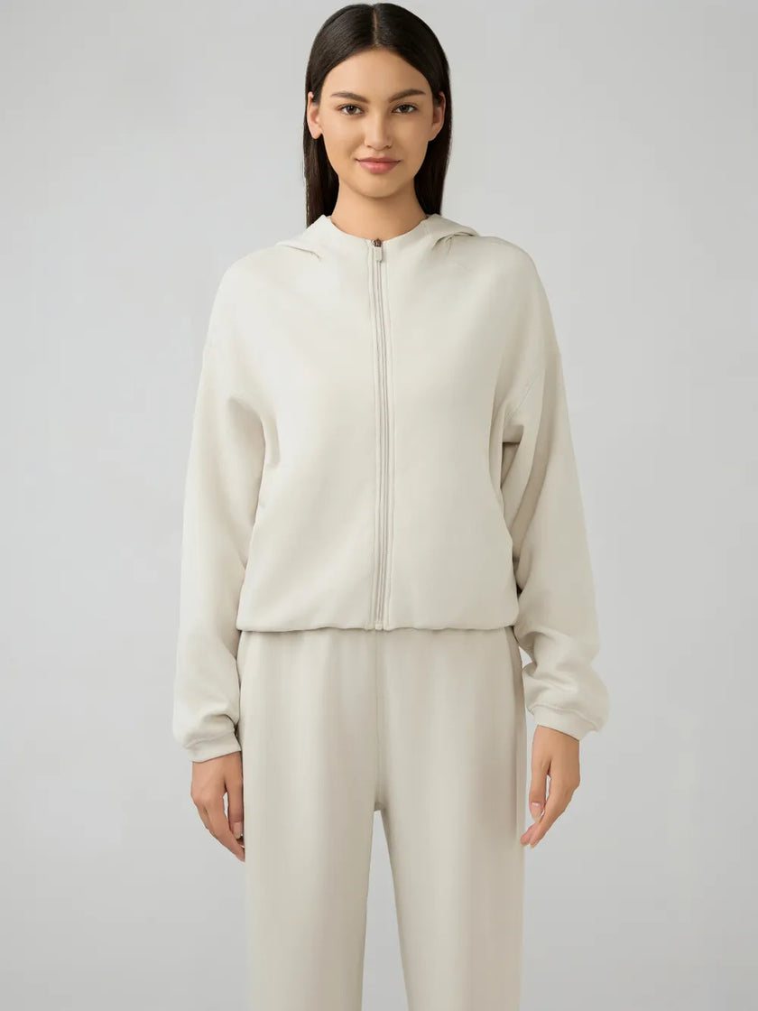 Cream zip-up hoodie with relaxed fit and dropped shoulders, front view.