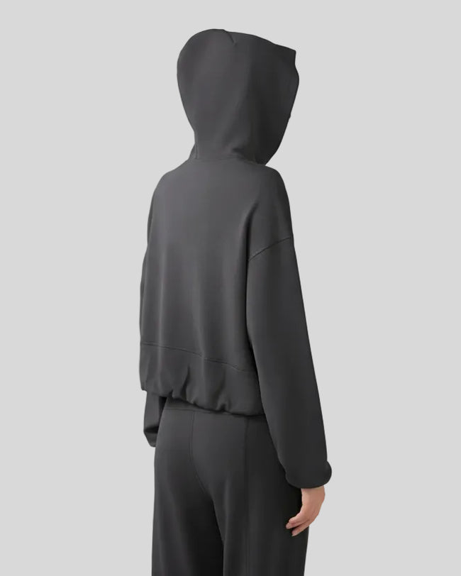Back view of dark gray zip-up hoodie with hood and relaxed drape