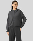 Angled front view showing dropped shoulders and clean zip-up design in Dark Gray