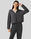 Dark gray hoodie worn half-zipped, styled for layering.