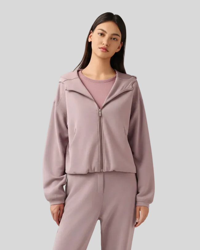Dusty pink zip-up hoodie with relaxed fit and dropped shoulders, front view.