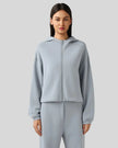Light blue zip-up hoodie with relaxed fit and dropped shoulders, front view