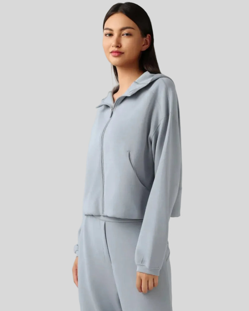 Light blue hoodie worn half-zipped, styled for layering.