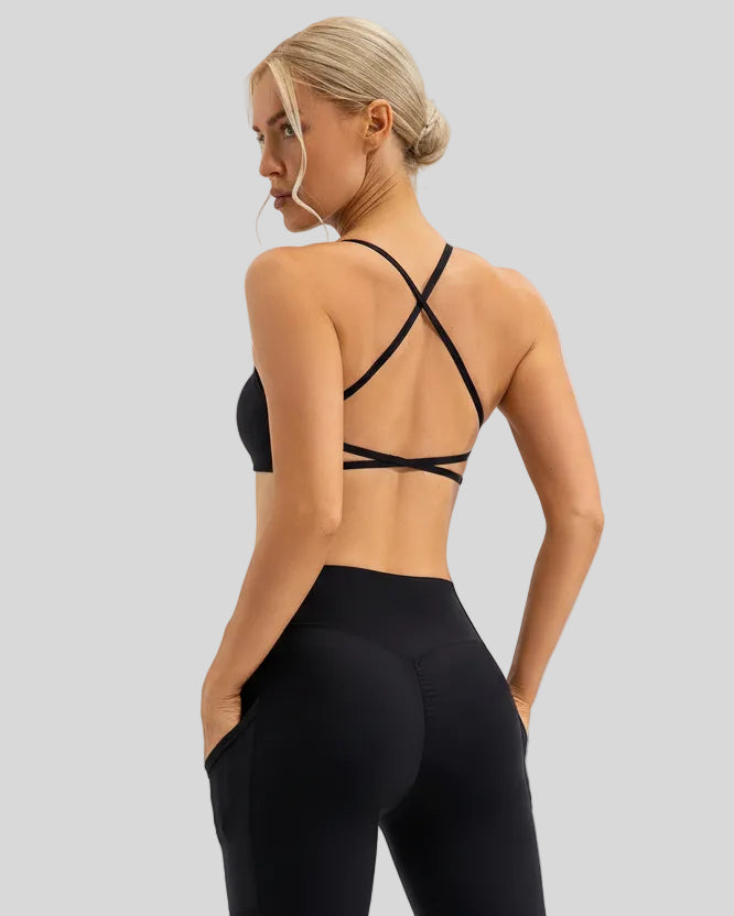 Black medium-support sports bra with cross-over back detailing and a smooth finish