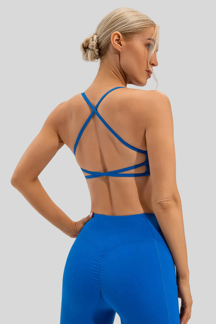 Blue medium-support sports bra with cross-over back detailing and a smooth finish