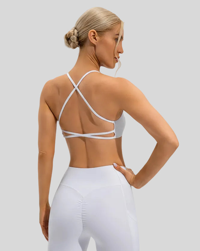 White medium-support sports bra with cross-over back detailing and a smooth finish